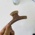 Detail of a brown translucent resin hair claw clip with multi-tooth grip and metal spring - Medium-8cm / Transparent Brown
