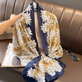 Navy blue and gold floral silk scarf for women styled on a luxury leather background - Navy Blue