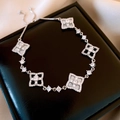 Detail view of silver heart pendant bracelet with clover links on leather jewelry box - Bracelet-Silver-White