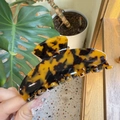 Detail of large tortoiseshell acetate claw clip showing glossy finish and amber texture - Large / Light Tortoise