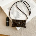 Macro shot of leopard print mini bag pendant with silver snap button and hand-stitched edges - Square / Dark Coffee
