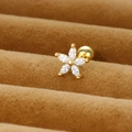 Macro detail of a gold flower stud earring with zircon petals in a brown velvet box - Gold/White Zirconia