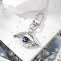 Turkish Blue Evil Eye keychain with hollow silver alloy frame on white stone - Silver