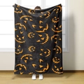 Close-up of soft flannel Halloween blanket featuring orange pumpkin face prints - Style 9-Black with Orange Pumpkin Faces