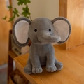 Sitting gray plush elephant toy for babies with soft white inner ears and curved trunk - Grey With White Ear Core