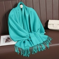 Elegant turquoise jacquard wrap scarf with woven tassels on a minimalist hanger - Cyan Blue (T003-97)
