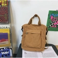 Khaki brown vintage canvas backpack with front zipper pocket in a minimalist design - Brown