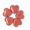 Set of five polished red jasper heart stones with natural dark veins on white background - Red Jasper