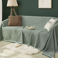 Green waffle weave cotton sofa cover blanket draped over a couch in a cozy home setting - 90x90cm / Green