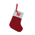 Red knit Christmas stocking with white cuff and red embroidered letter W hanging - Letter W