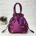 Detail view of purple satin bucket bag with floral embroidery and drawstring closure - Rose Purple