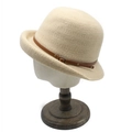 Detail of light beige knitted cloche hat with brown leather strap and bronze metal buckle - M (56-58cm) / Beige
