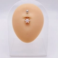 Silver flower belly button ring with zircon stones on a professional display model - Sweet Flower