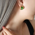Retro emerald crystal earrings with gold plated frame shown on a female model - Gold Earrings