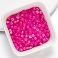 Pink round glass beads with crackle effect in a white ceramic bowl for DIY jewelry making - Glaze Ice Crack Bead - Light Rose White