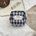 Detail view of square navy checkered storage pouch with fabric label on natural wood surface - Square Sanitary Bag / Blue