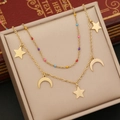 Detail of double-layer gold necklace with colorful beads, stars, and moon pendants - Star & Moon Style