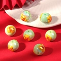 Macro shot of green festive DIY beads with golden fortune bag and red character patterns - Blessing Bag / Green