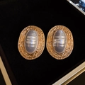 Primer plano de pendientes ovalados vintage dorados con piedra de ópalo sintético - Dorado