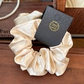 Elegant champagne satin scrunchie with lace trim and handmade tag on vintage decor - Rose Satin Beige
