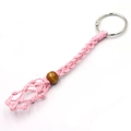 Pink hand-woven mesh keychain with adjustable cord and yellow wooden bead detail - Pink