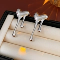 Macro detail of silver heart-shaped lava stud earrings in a premium jewelry box - Silver Pin / Silver