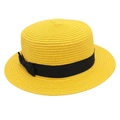Close-up of woven straw hat with flat top, yellow texture, and black ribbon bow detail - Yellow