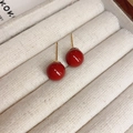 Macro detail of red bead stud earrings with gold plating on a beige fabric jewelry box - 10mm / Gold-Red-10mm