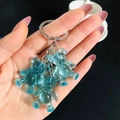 Close-up of three blue jelly gummy bear pendants on a high-quality metal keychain - Sky Blue