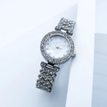 Detailed view of silver crystal watch band and mother-of-pearl dial with diamond accents - Silver Rhinestone Face