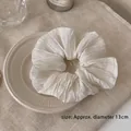 Detail shot of a white oversized ruffled scrunchie showing 13cm diameter on texture fabric - Small / Pleated Small-White