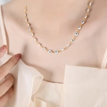 Golden titanium steel necklace with white evil eye beads shown on a model neck - White Blue Necklace