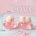 Detailed view of two cute mini resin pig ornaments with 2.2cm and 2.4cm dimensions. - Pig with Swim Ring