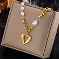 Elegant gold titanium steel necklace with hollow heart pendant and baroque pearl on jewelry box - Baroque Pearl Heart Pendant Style (N1248)
