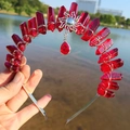 Detail of red crystal wizard crown headband featuring a solar sun charm and teardrop pendant - Wine Red/Sun/Wine Red Pendant