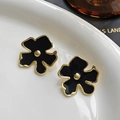 Floral stud earrings in black enamel and gold finish on white ceramic display - Black Enamel Floral (FYD6036EH-black)