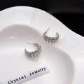 Silver C-shaped stud earrings with crystal rhinestones on a ceramic tray - Irregular C-shaped Wave Silver Rhinestone Style (E4278-4/Silver) / Silver