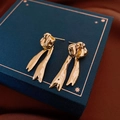 Golden bow tassel earrings with a polished mirror finish on a velvet jewelry box - Crinkled Bow Ribbon (19# Silver Pin-Gold-Crinkled Bow Studs)
