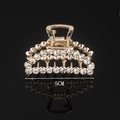 Detail view of a 5cm golden alloy hair claw clip with sparkling rhinestones and reflection - Full Rhinestone Mini Crescent 5CM Claw Clip