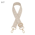 Close-up of adjustable woven shoulder strap with geometric jacquard pattern and gold hooks - Silver Clasp / Off White