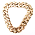 Macro detail of high-gloss gold plastic Cuban link dog collar with large curb links - 30cm / Rose Gold