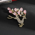 Elegant gold deer brooch with sparkling rhinestones and pink crystal antlers on black background - Pink Deer