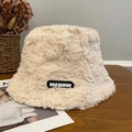 Beige faux fur teddy bear bucket hat featuring a Drojamor woven label on a wooden desk - Black Label Fisherman-Khaki