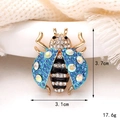 Detailed size view of crystal ladybug brooch measuring 3.7cm by 3.1cm on knit fabric - Style 8-Blue White Rhinestone Insect Brooch