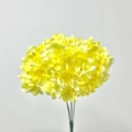 Detailed view of vibrant yellow artificial hydrangea petals and green stems on a neutral wall - Yellow