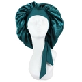 Detail of dark green satin sleep cap with wide elastic ribbons on mannequin head - Green