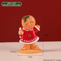 Gingerbread girl figurine in a red Christmas dress holding a candy cane ornament - Girl with Cane - Small