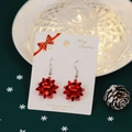 Festive Christmas earrings featuring red ribbon bow design on white card - Red Bow