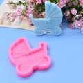Pink silicone baby stroller mold showing blue fondant with embossed Baby lettering - Baby Stroller
