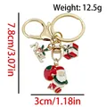 Santa Claus and gift box metal keychain with Noel plaque in festive gold-tone finish - ER1793-Santa Gift Box 8-shape Keychain